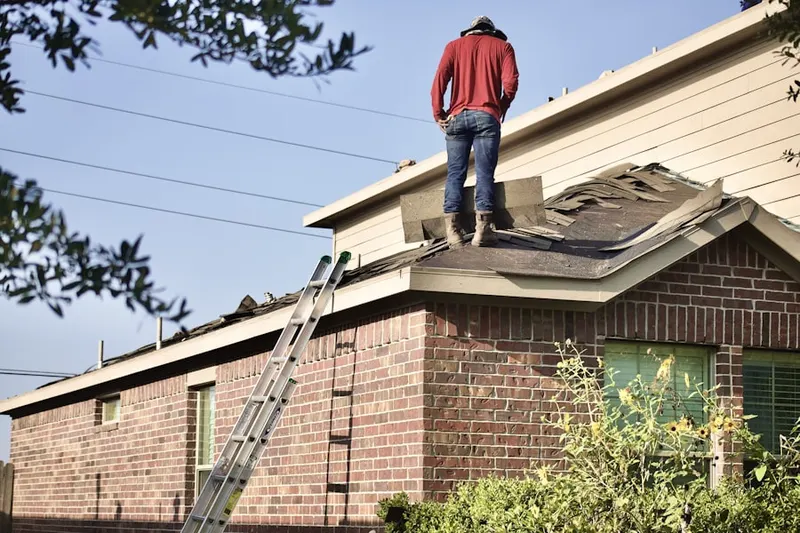 Professional roofer working on a residential roof in Oak View